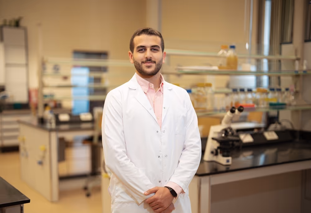 Student, Farid, working at a computer