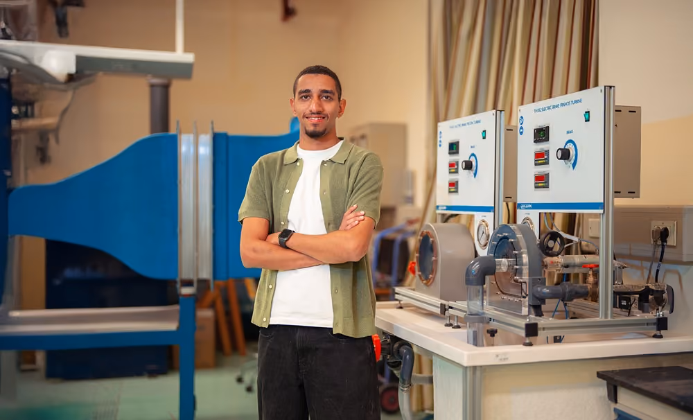 Student, Farid, working at a computer