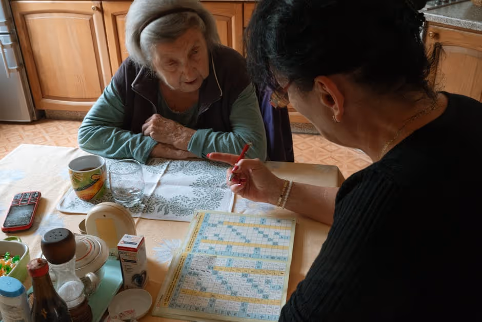 elderly woman and caregiver doing a puzzle at home - Dementia activities at home