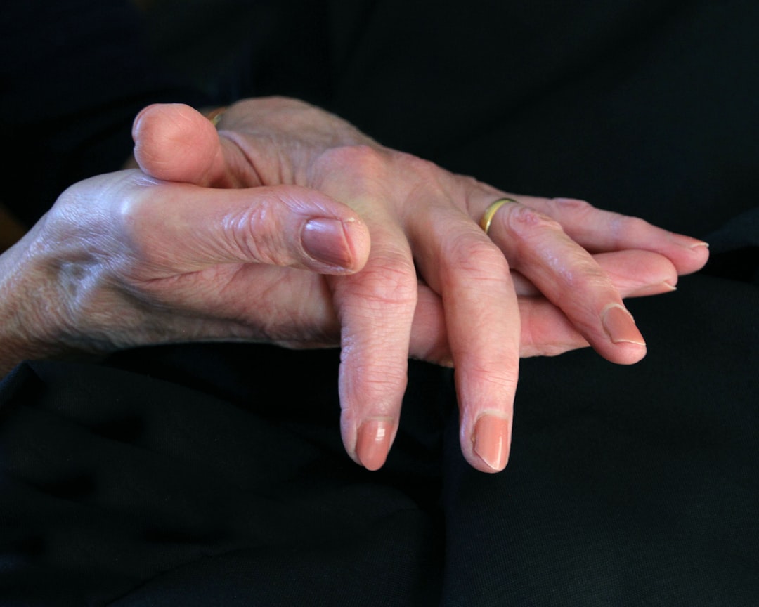 Caregiver holding elderly parent's hand - Support for caregivers