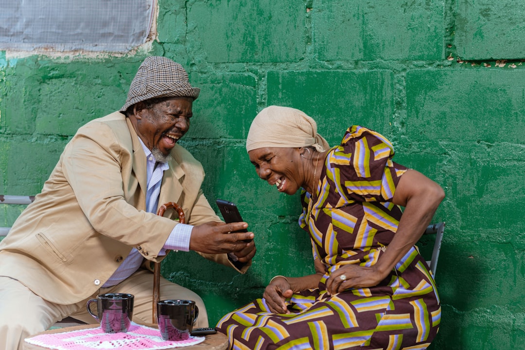 Elderly person and volunteer laughing together - volunteer companionship for the elderly