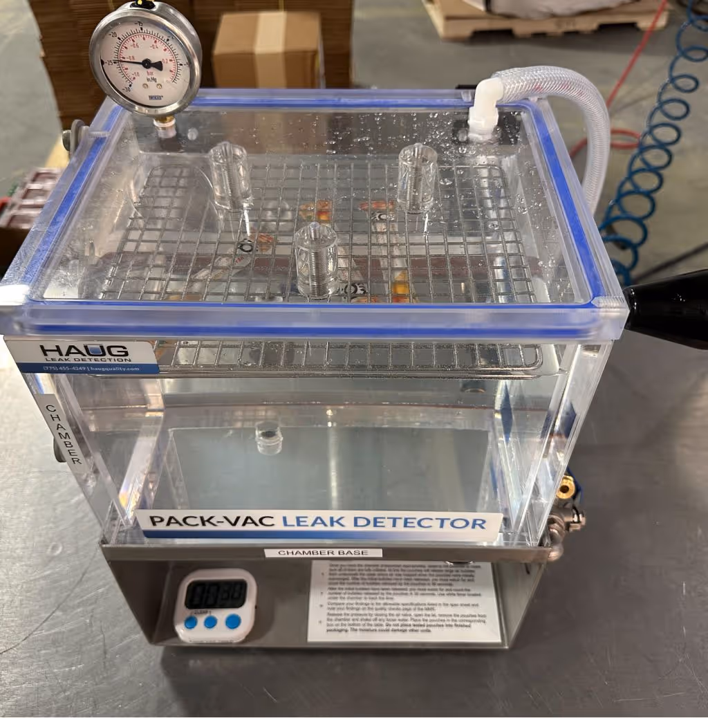 Vacuum-based Pack-Vac leak detector ensuring packaging integrity and seal quality during supplement manufacturing quality control | Steuart Nutrition