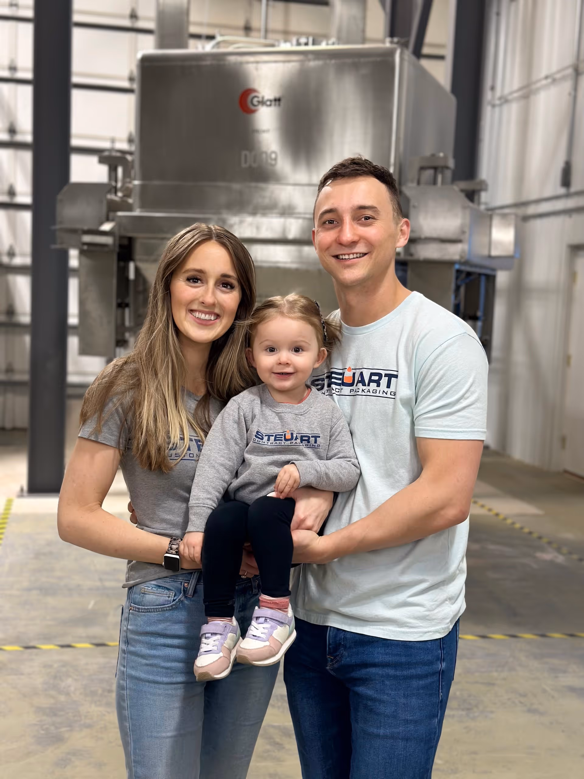 Ben, wife and daughter taking a picture inside the manufacturing plant | Steuart Nutrition