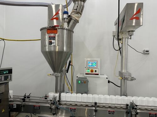Automated auger powder filling equipment precisely dispensing nutritional supplement powder into bottles on production line | Steuart Nutrition