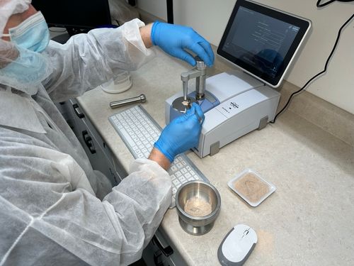 Lab technician conducting Fourier Transform Infrared (FTIR) spectroscopy on powdered supplement sample to verify ingredient authenticity and quality control | Steuart Nutrition