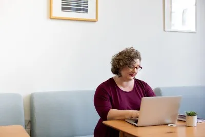 woman at home on laptop checking healthcare informtion
