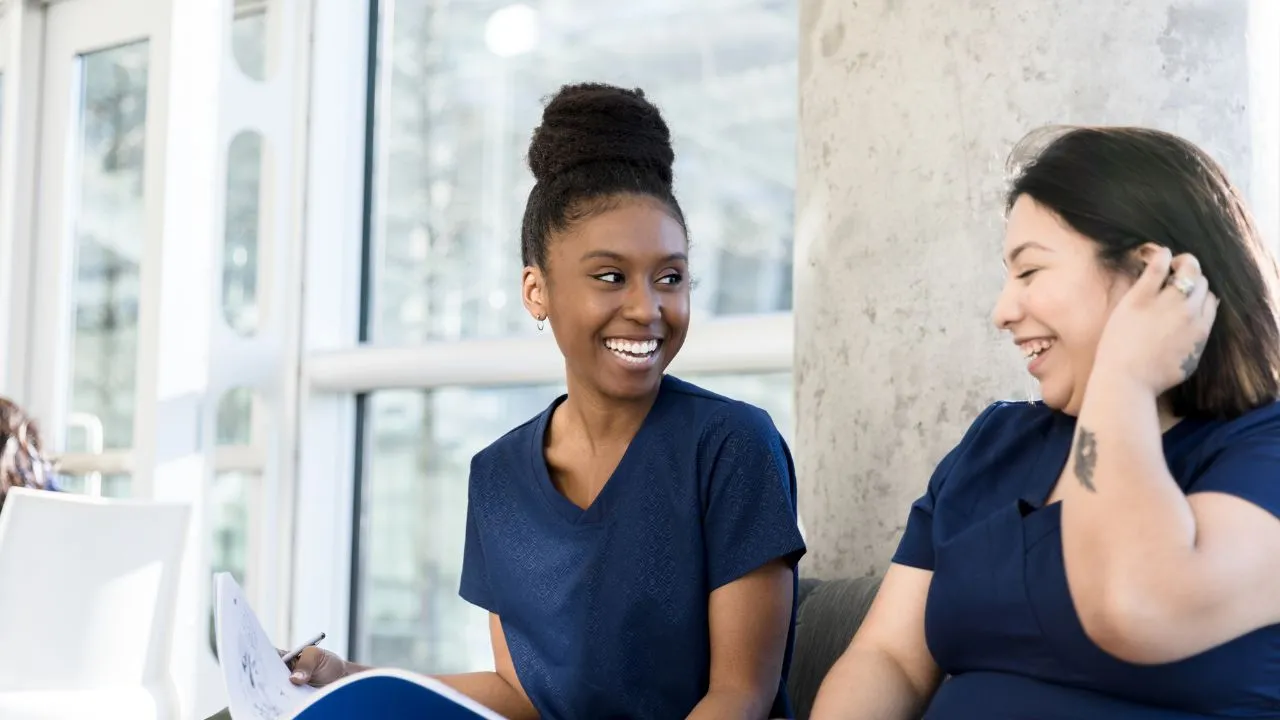 two nurses laughing at jokes
