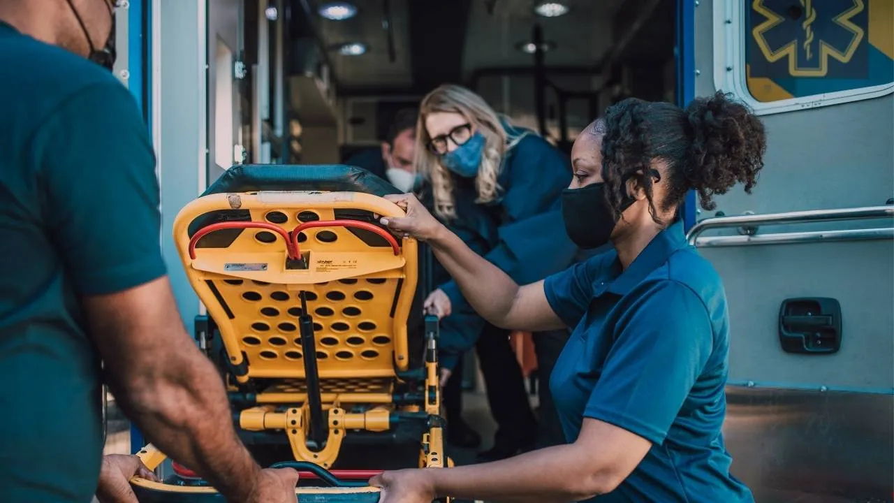 EMTs and nurses unloading a patient from an ambulance