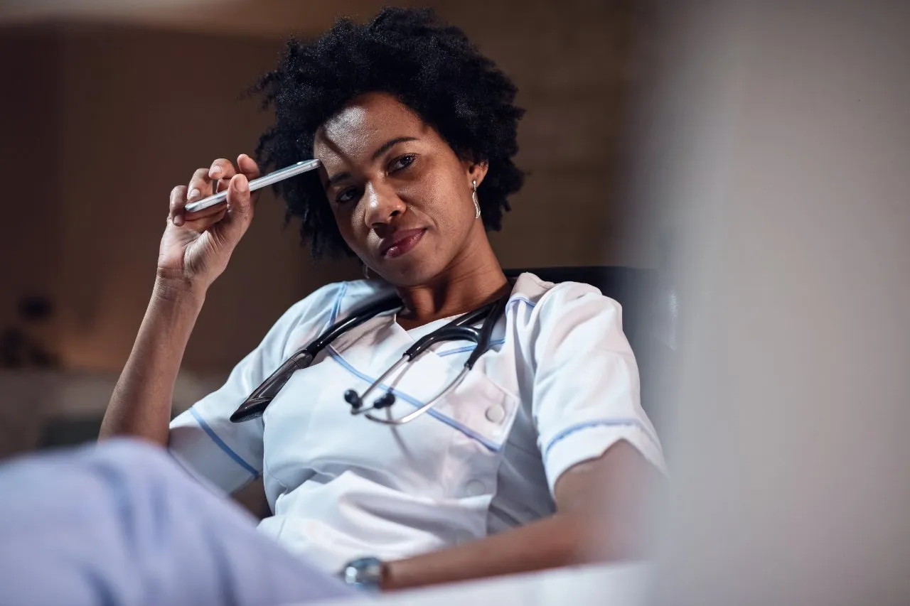 picture of a nurse thinking with her pen to her head