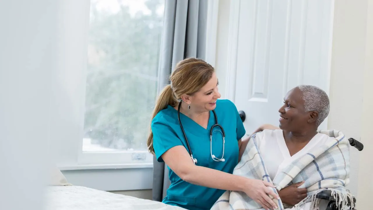 A nurse helping a middle-aged patient