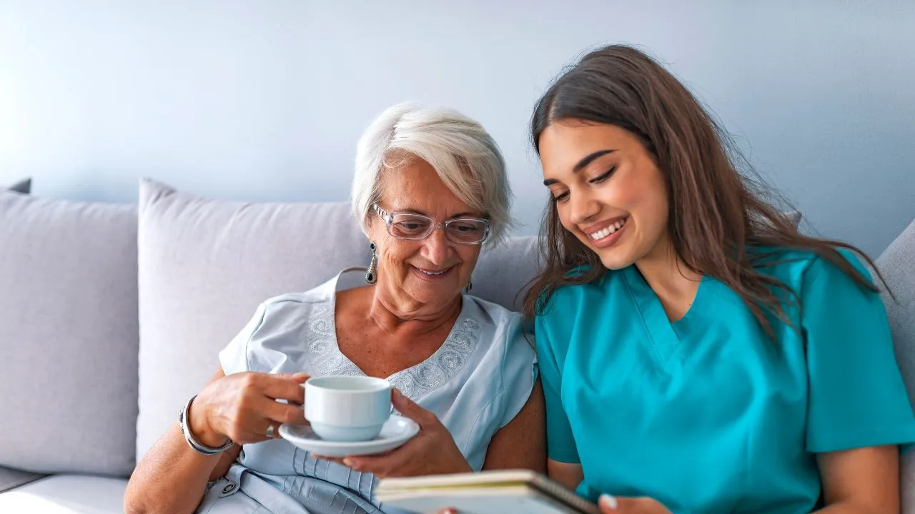 long term care nurse sitting near a patient