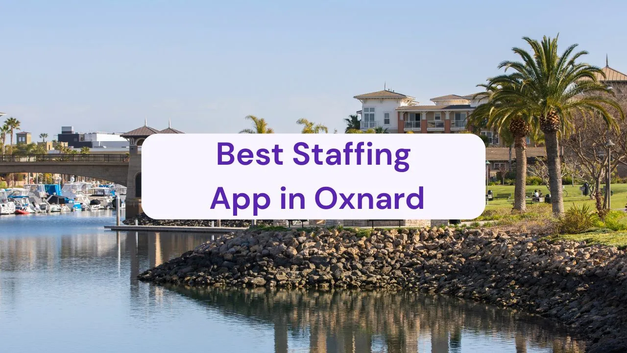a waterway that passes under a bridge with buildings in the distance