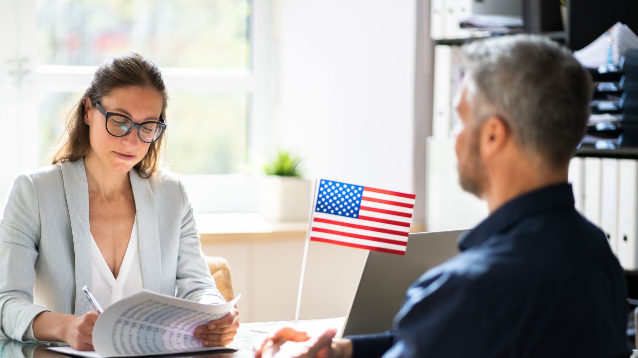 two people in an office with a us flag
