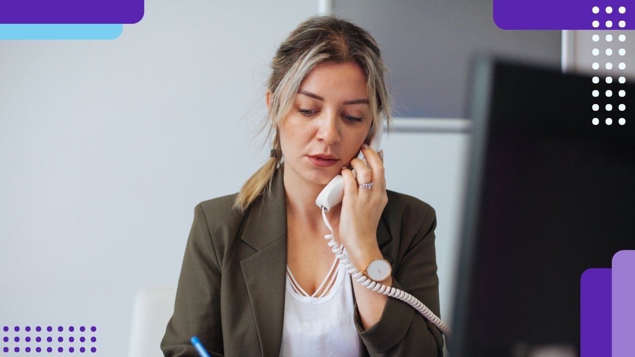 A woman in an office using a phone