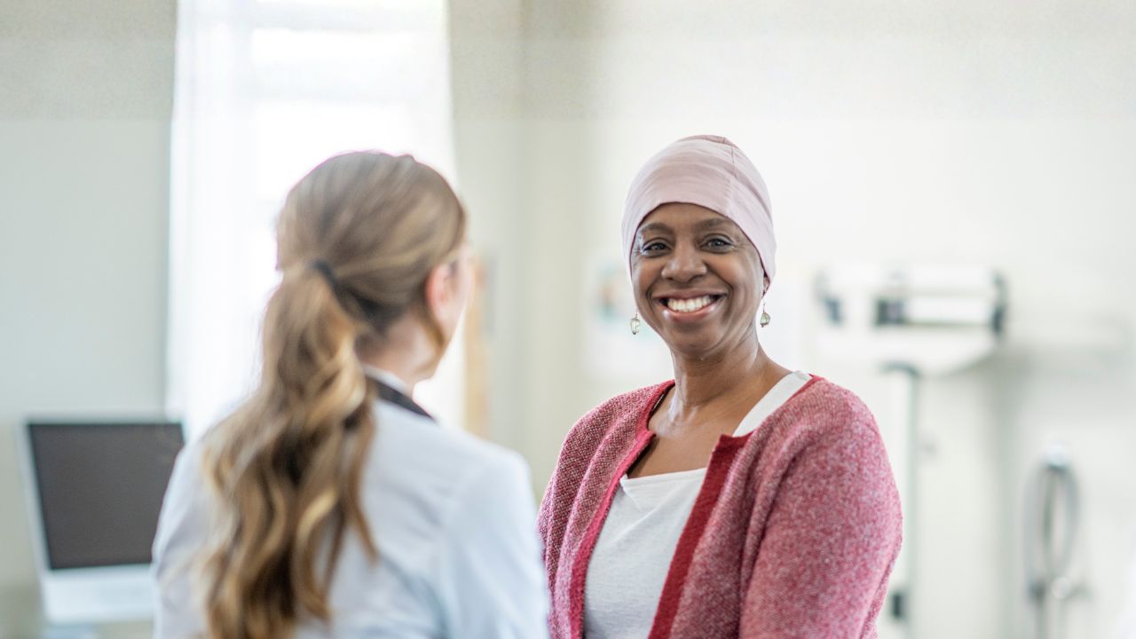 a clinician talking with a patient in a hospital room