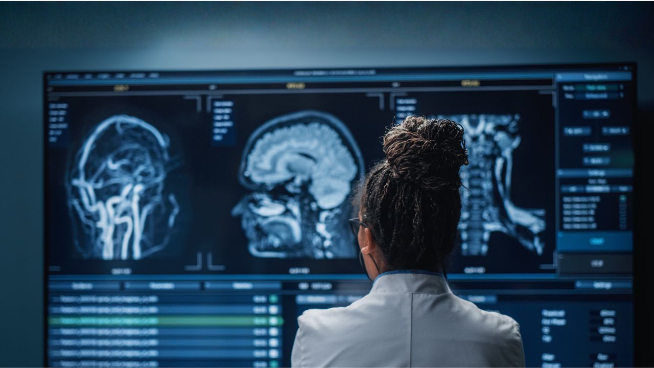 a doctor examines brain and spinal MRI scans