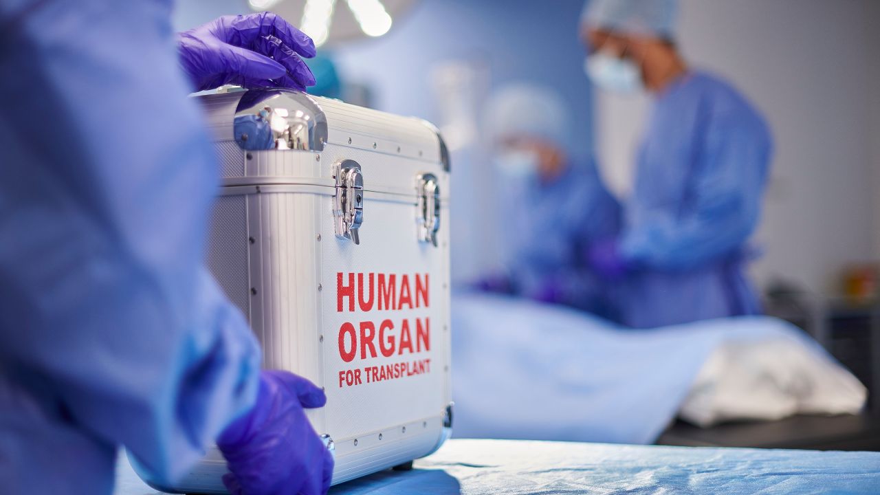 Nurses and a box with transplant label 