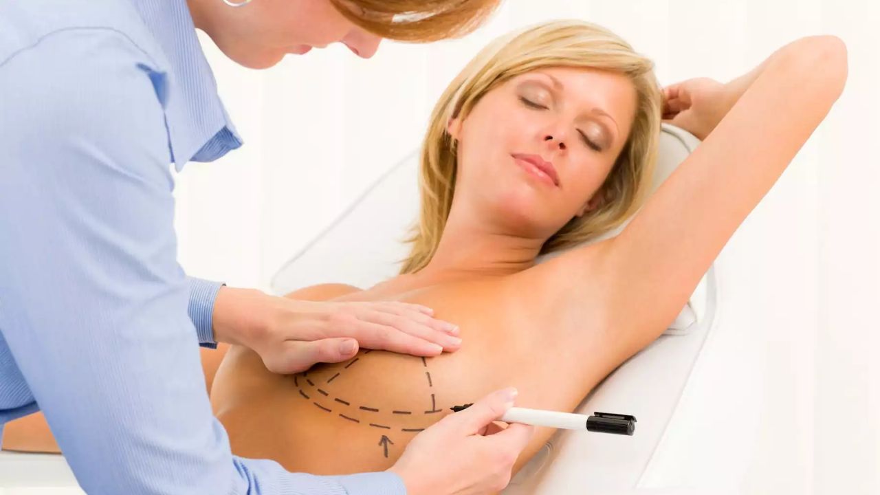 surgeon analyzing breast of patient