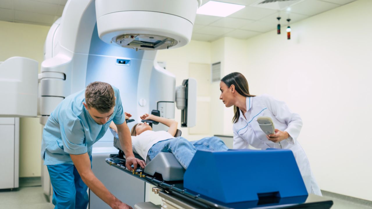 nurses with a patient in an oncology machine
