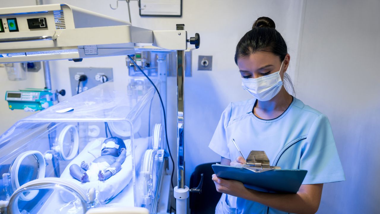 nurse caring for neonate patient in NICU Level 3C