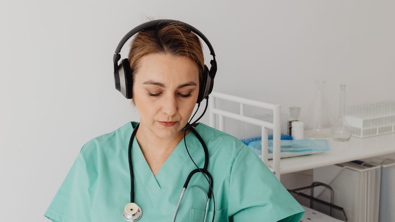 A nurse with headphones on