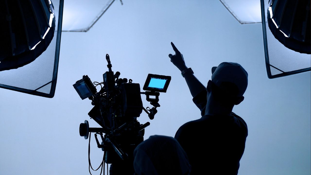 A silhouette of a camera operator on a television show set