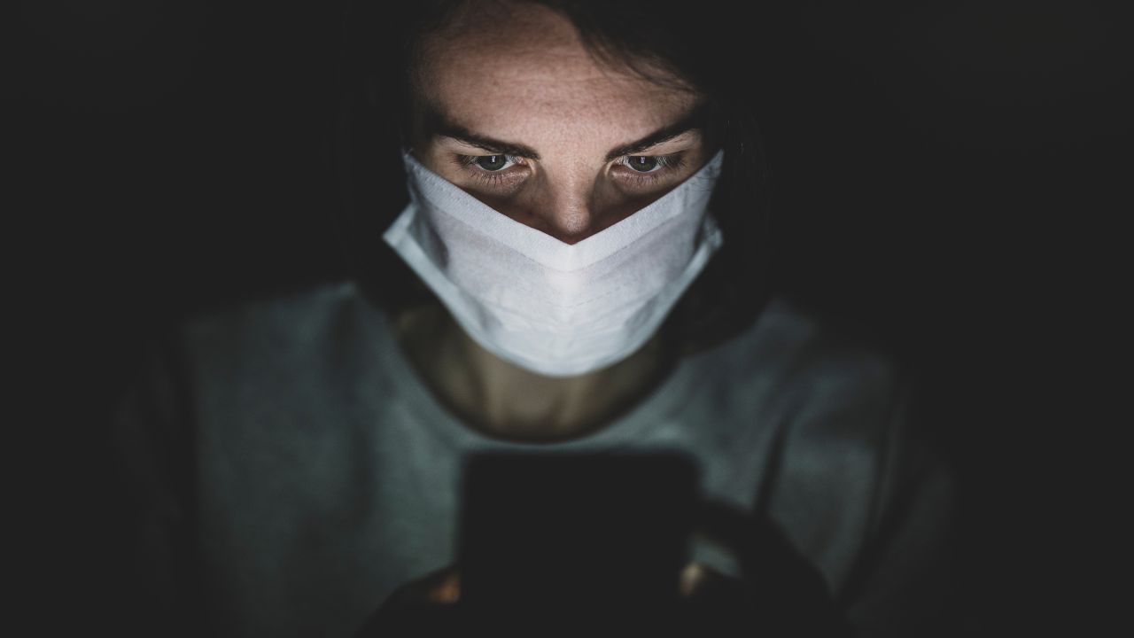 a nurse with a dark background behind