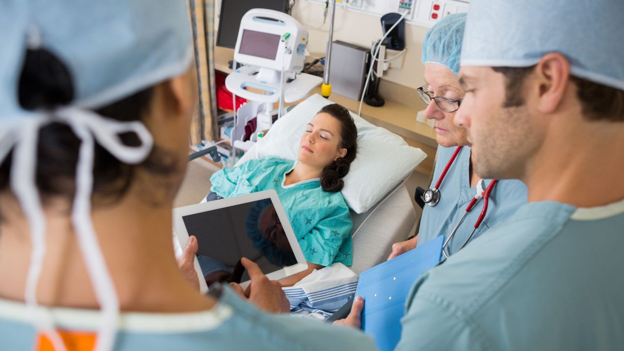 doctors and nurses , with a patient