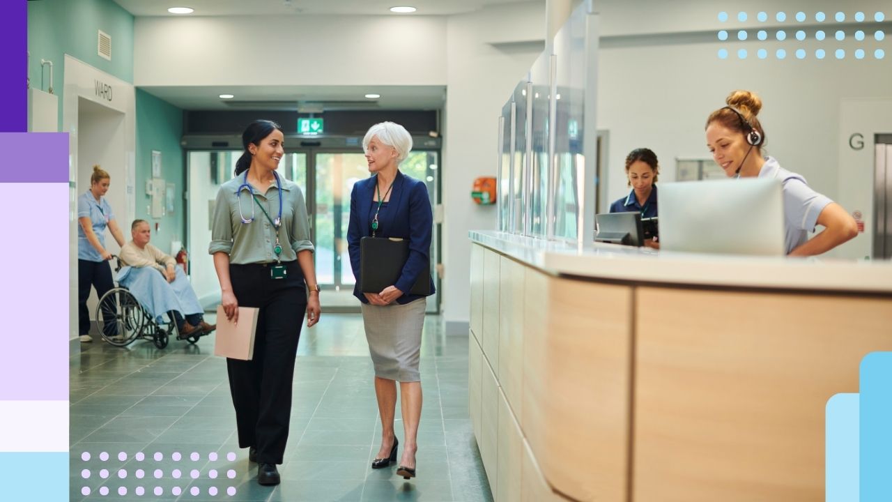 Two healthcare administrators walking in the hallway of a healthcare facility