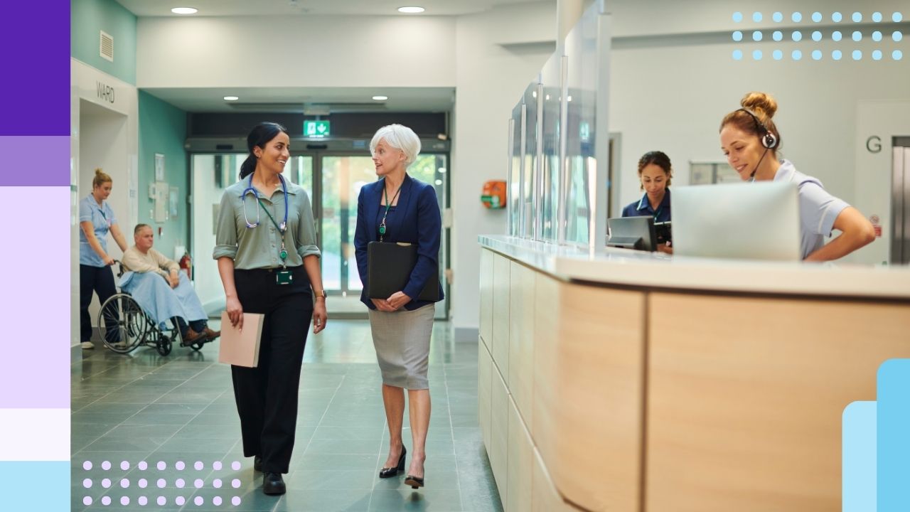 Two healthcare administrators walking in the hallway of a healthcare facility
