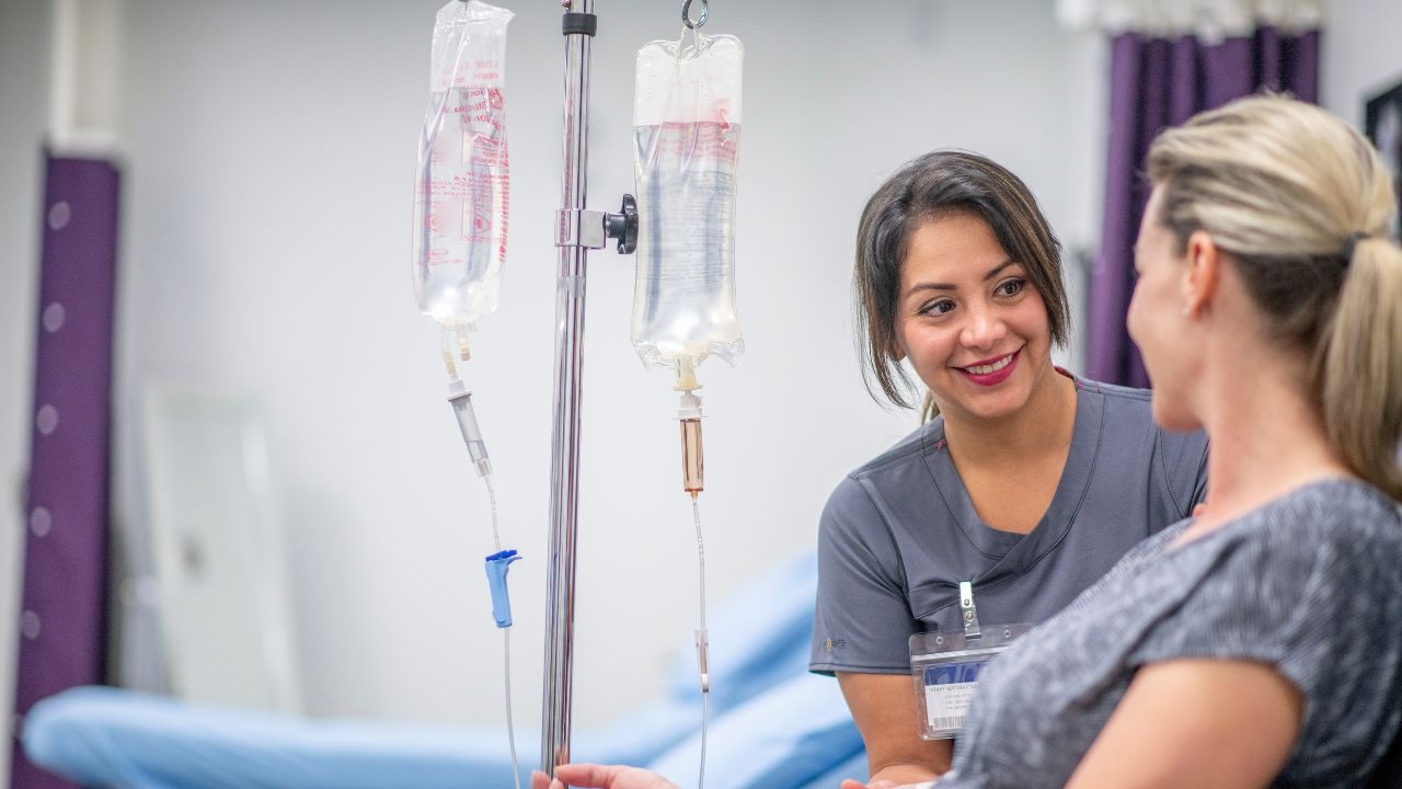 picture of an LPN administering IV with a patient