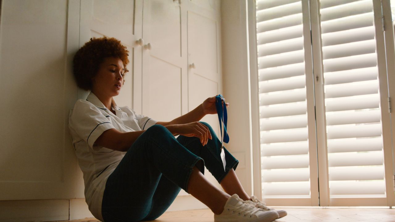 stressed out nurse sitting on the floor