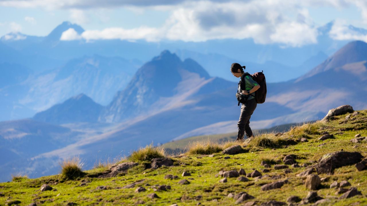 a girl hikking at the mountains