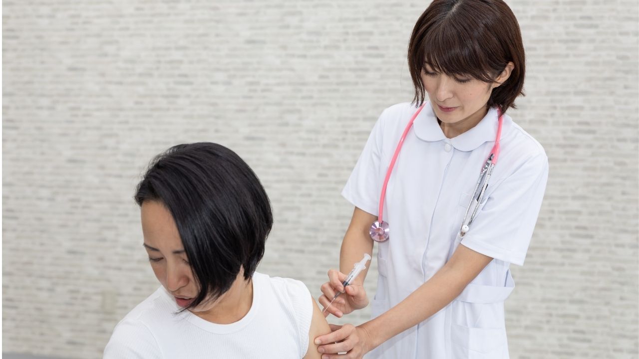 Nurse administering an injection to a patient in a clinical setting