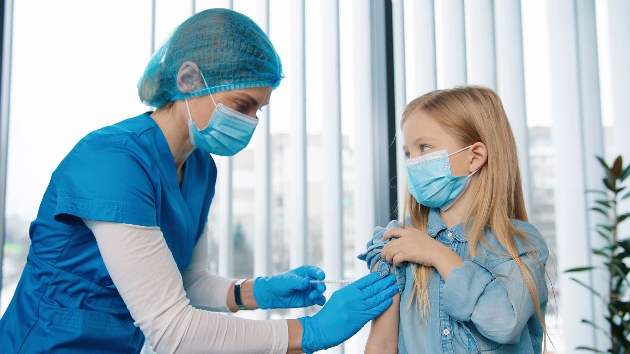Nurse preparing to vaccinate a child in a clinic