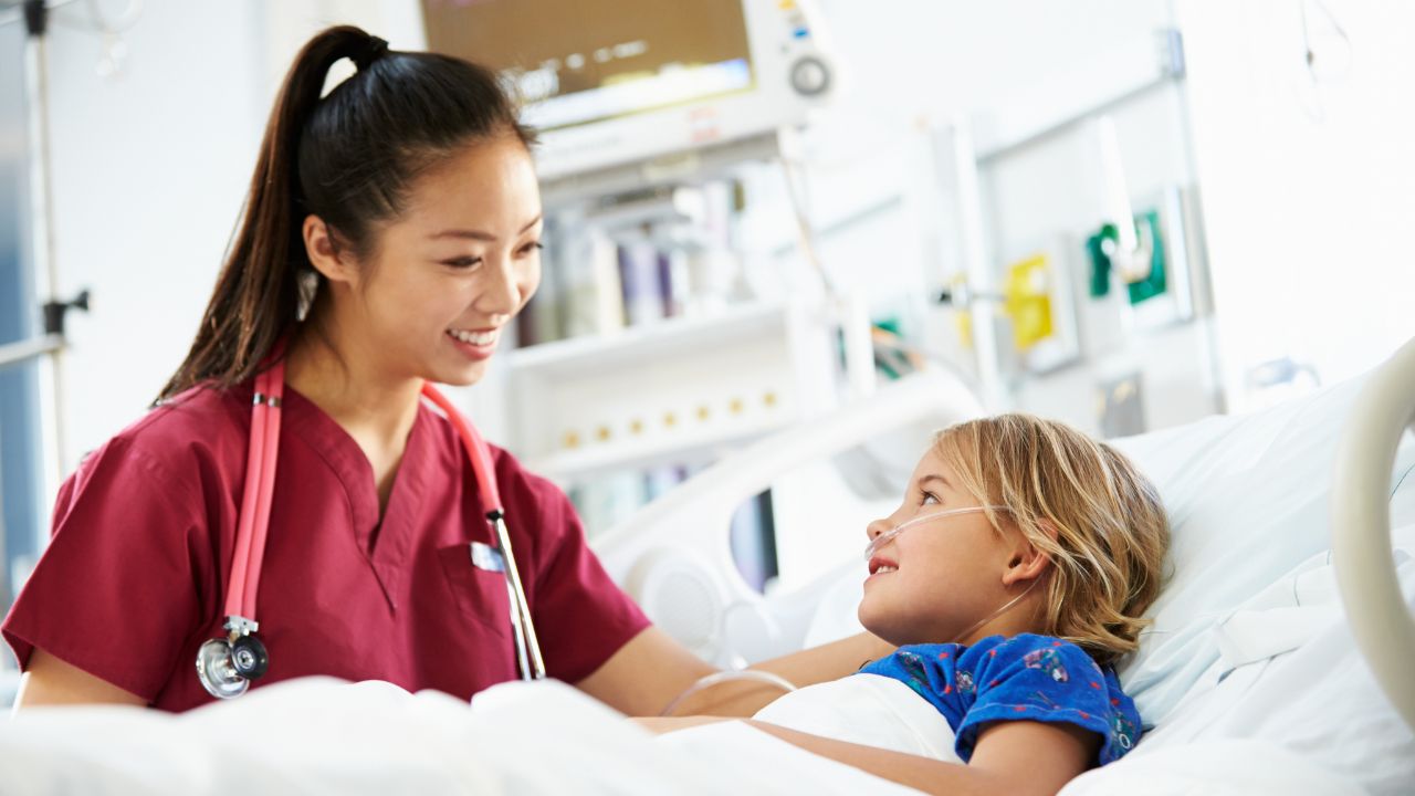 Nurse examining a young child in a clinical setting