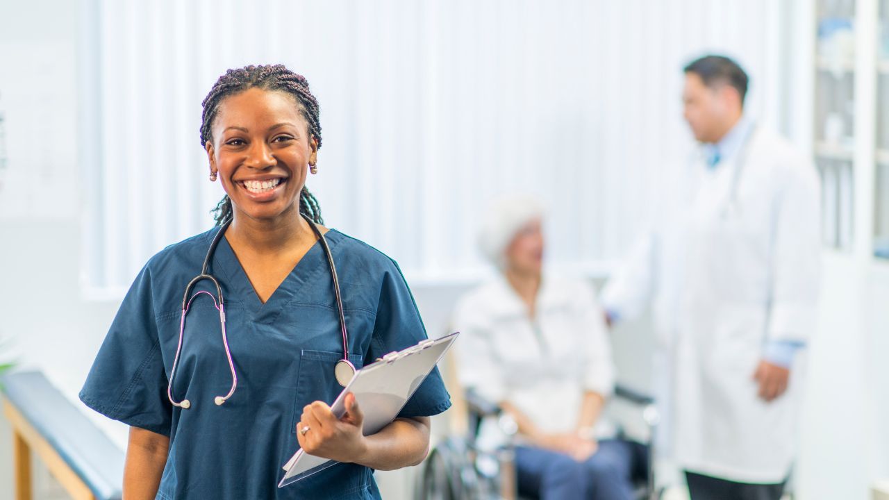 picture of nurse smiling holding a document 