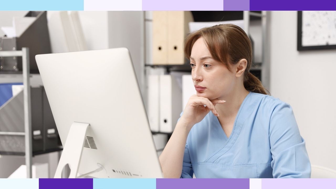 A woman working at a computer in an office