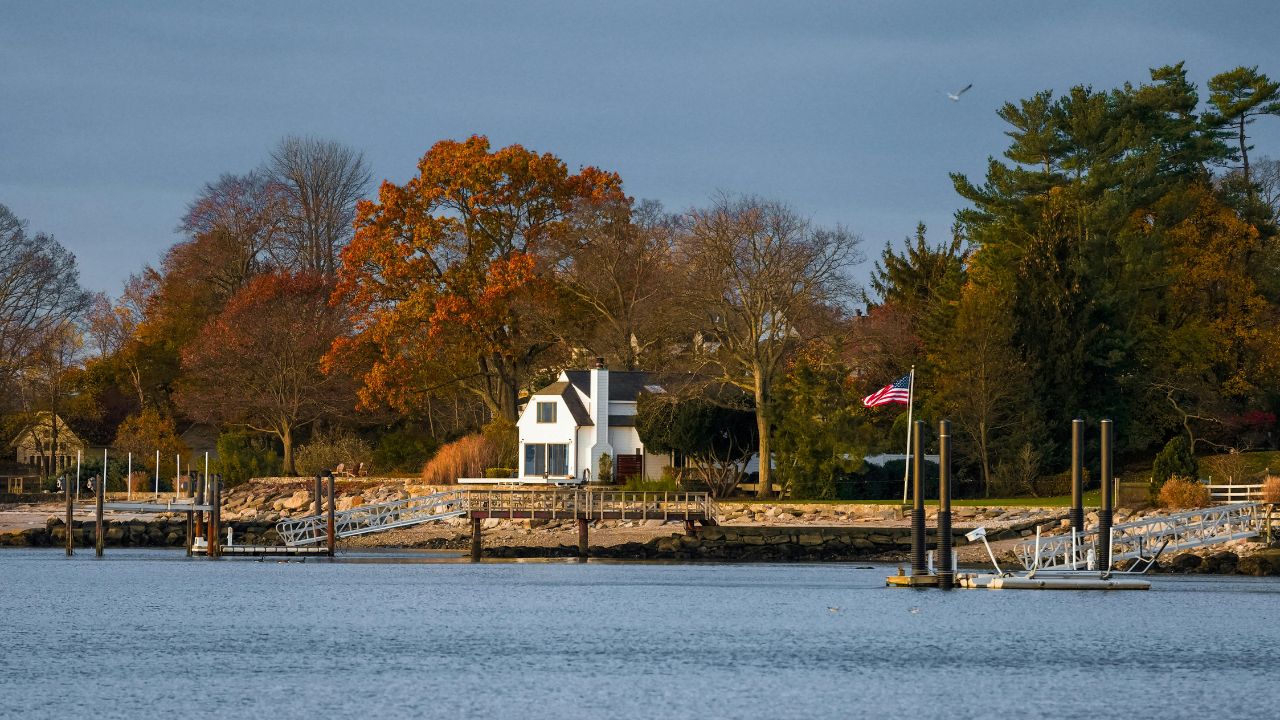 a lake, a house, nature and a deck