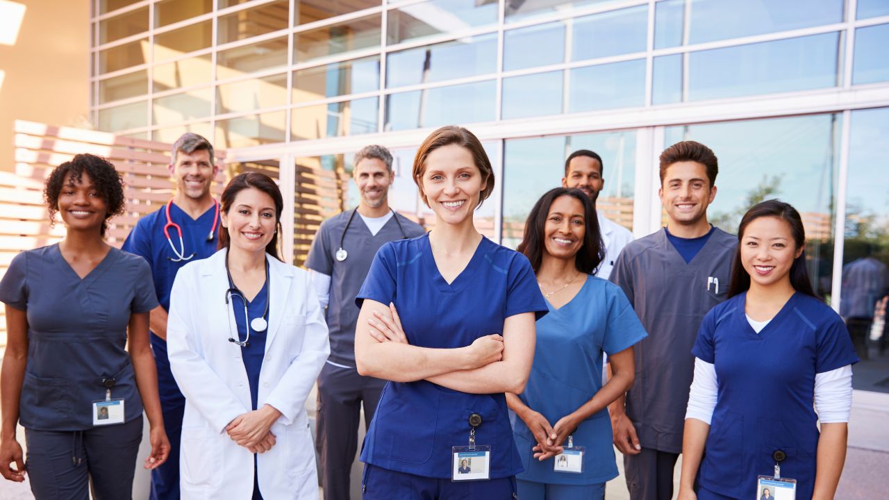 picture of healthcare workers in front of a hospital