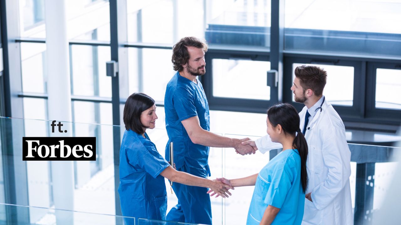 picture of four nurses shaking hands and feat. Forbes