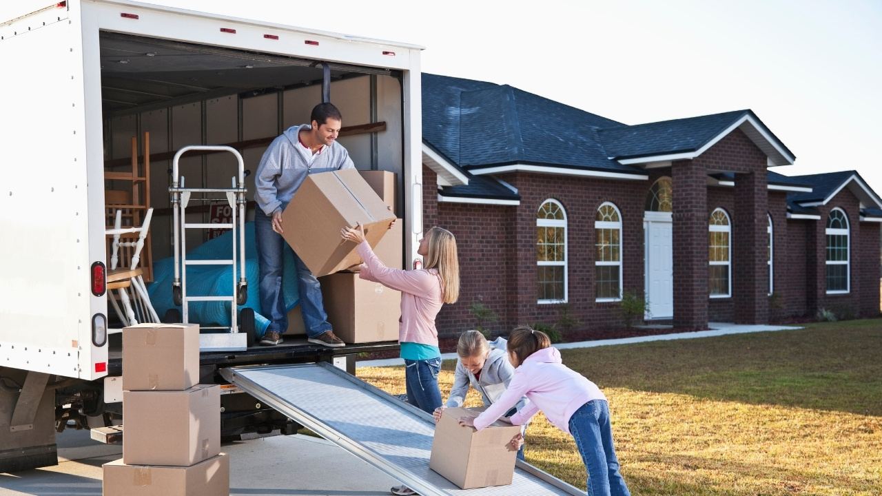 A family unloading their boxes from a moving truck