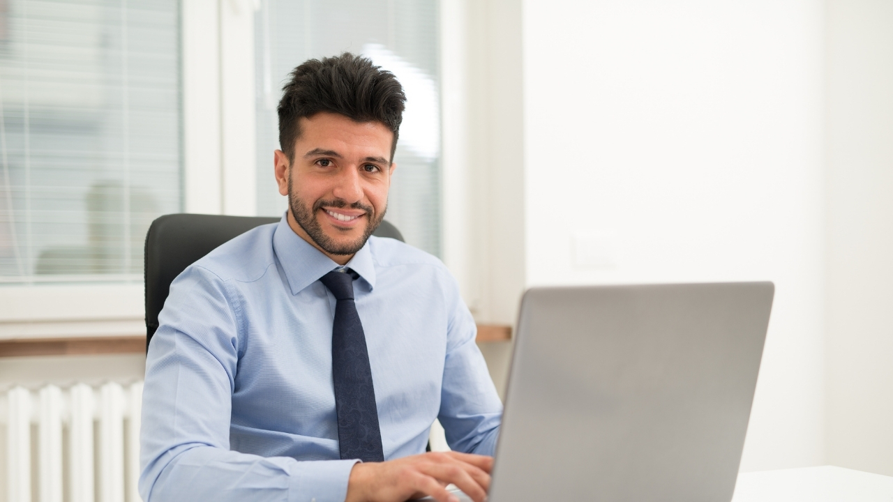 A office worker sitting at a desk and looking forward