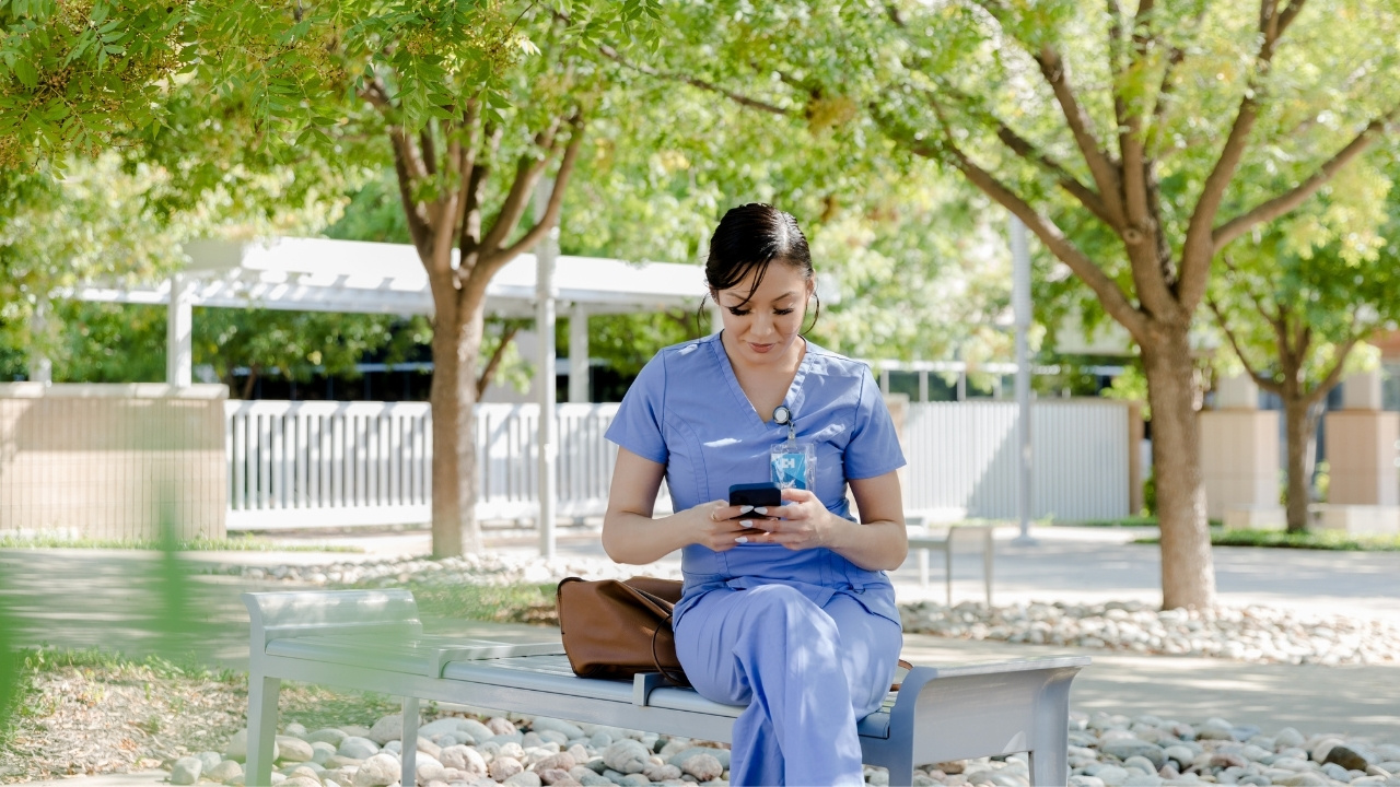 Nurse or healthcare worker, standing outside of a hospital