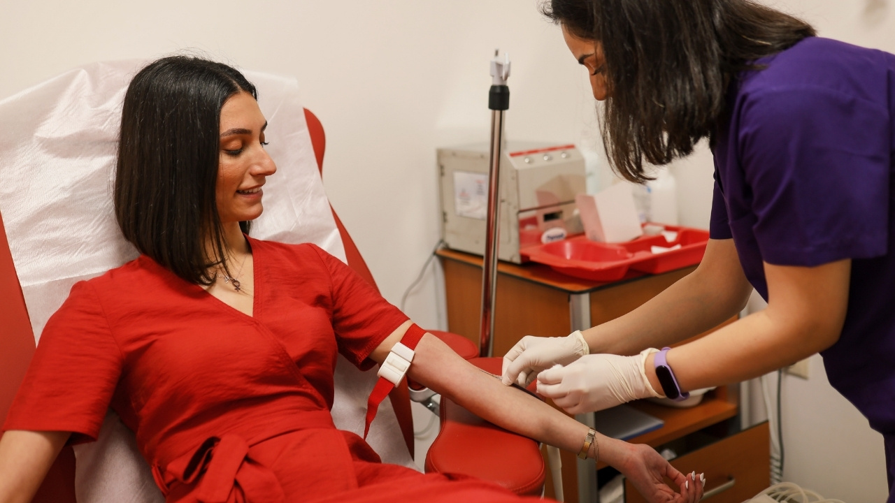 A nurse taking someone's blood