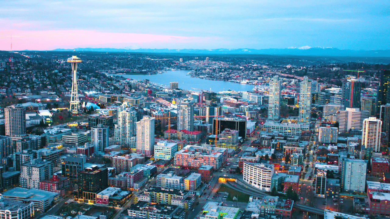 space needle surrounded by lit up buildings at night