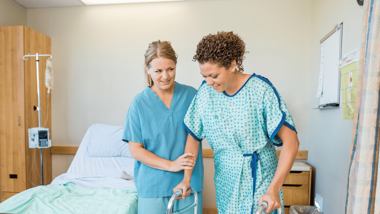 A nurse helping a patient move
