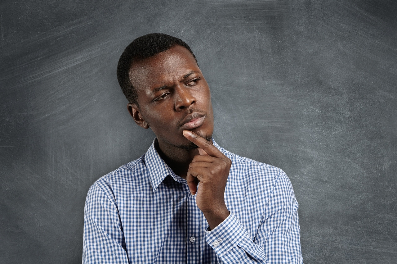 Man holding his chin thinking and pondering on his next decision