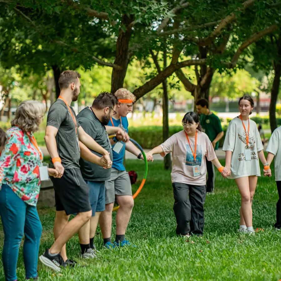Camp games in a circle under the trees