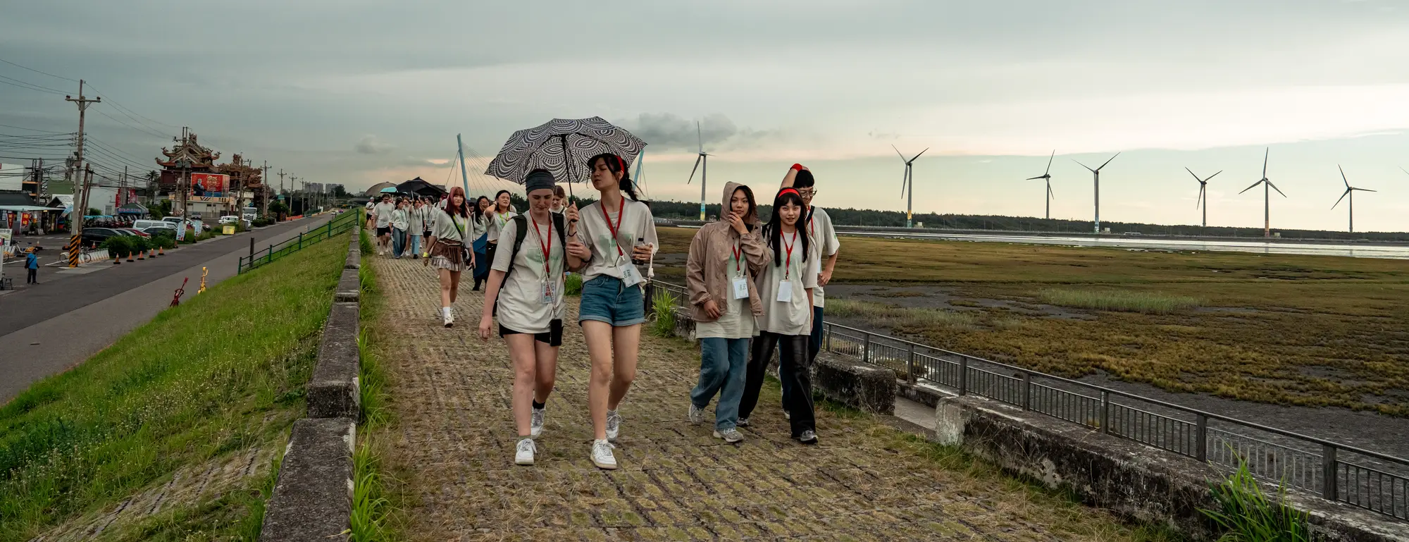 Students walking together along the boardwalk at Gaomei Wetlands